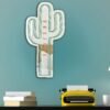 Decorative mirror shaped like a cactus with a golden frame.