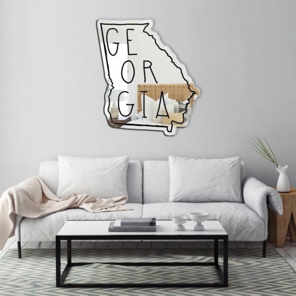 Text 'Georgia' painted in white on a mirror.