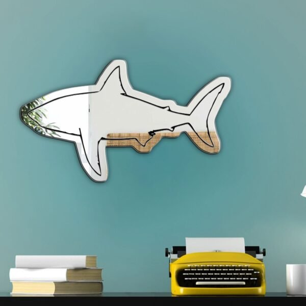 Reflective shark-shaped mirror on a white background.