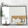 Irregularly shaped mirror with a rustic Colorado home theme.