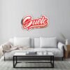 Red abstract-shaped mirror by Suelo on white wall.