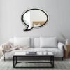 Wall-mounted mirror resembling a blank speech balloon.