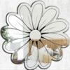 Irregularly shaped mirror with daisy-inspired contours.