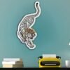 Wall-mounted mirror with artistic tiger frame design.