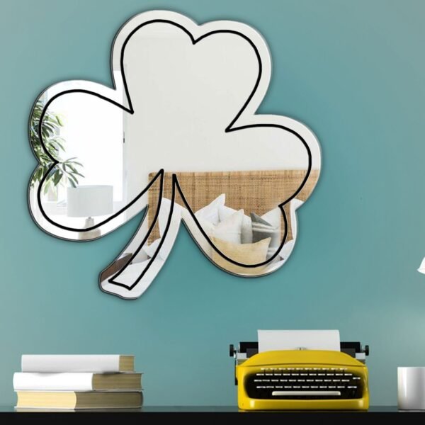 Green shamrock-patterned frame surrounding a round mirror.