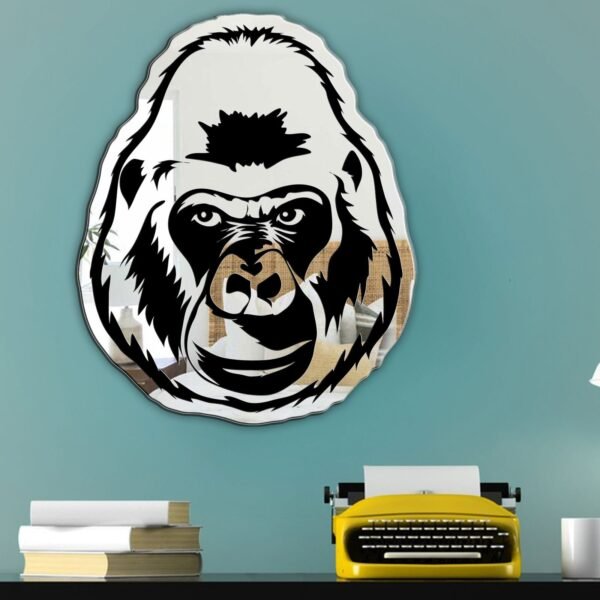 Gorilla-shaped mirror with reflective glass and black frame.