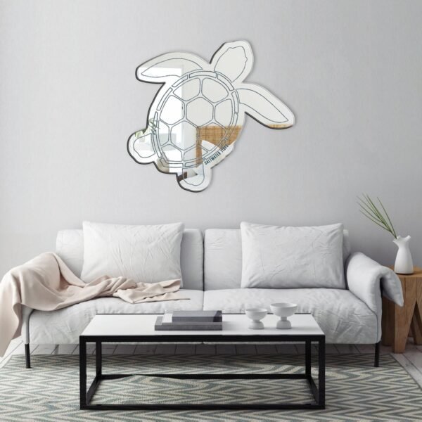 Sea turtle-shaped mirror surrounded by saltwater tide patterns.