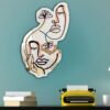 Decorative mirror with sculpted faces surround.