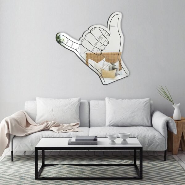 Decorative mirror shaped like a 'hang loose' gesture.