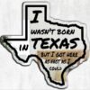 Decorative mirror with 'I Wasn't Born In Texas' slogan.