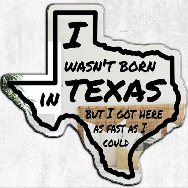 Decorative mirror with 'I Wasn't Born In Texas' slogan.