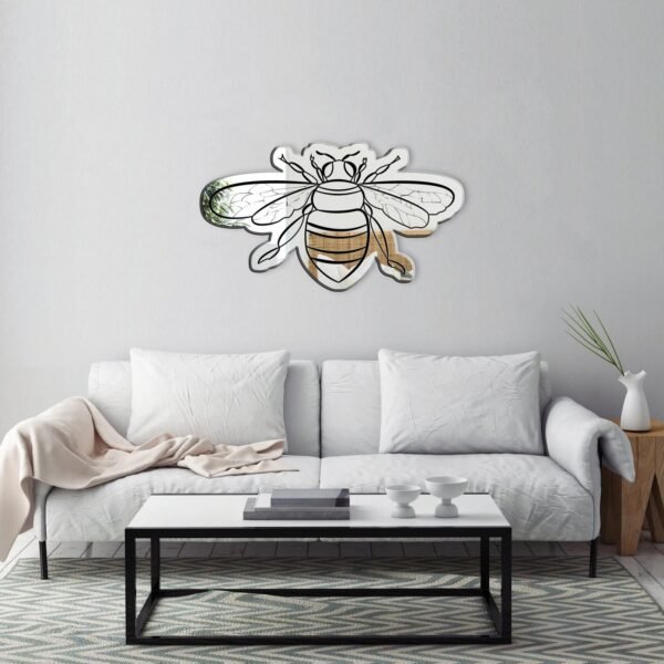 Bee-shaped adhesive mirror with a reflective surface and intricate wing and body details, perfect for decorative purposes.