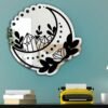 Crescent moon-shaped wall-mounted mirror.