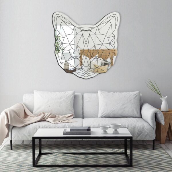 Wall-mounted geometric mirror shaped like a cat's face.