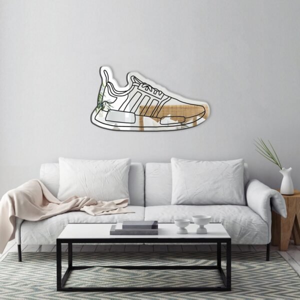 NMD sneaker silhouette displayed on a mirror.