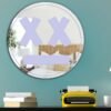 Circular mirror featuring a purple "Game Over" face with artistic design.
