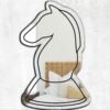 Reflective mirror shaped like a white knight chess piece.