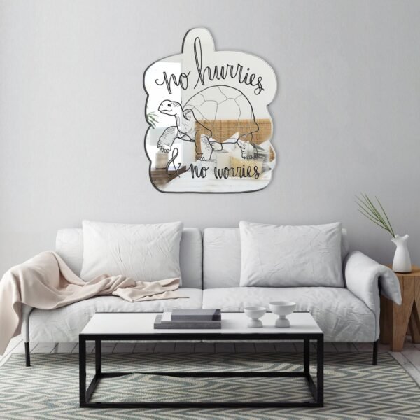 "No Hurries and No Worries" calligraphy with tortoise illustration in black and white on a mirror.