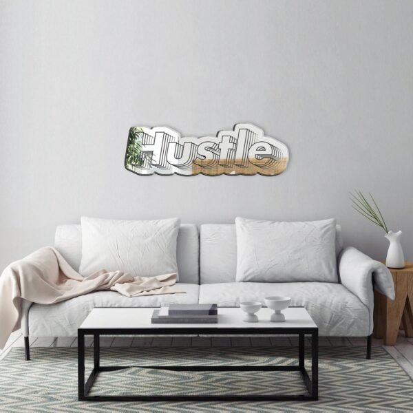 Wall mirror with 'HUSTLE' inscribed at the top frame.