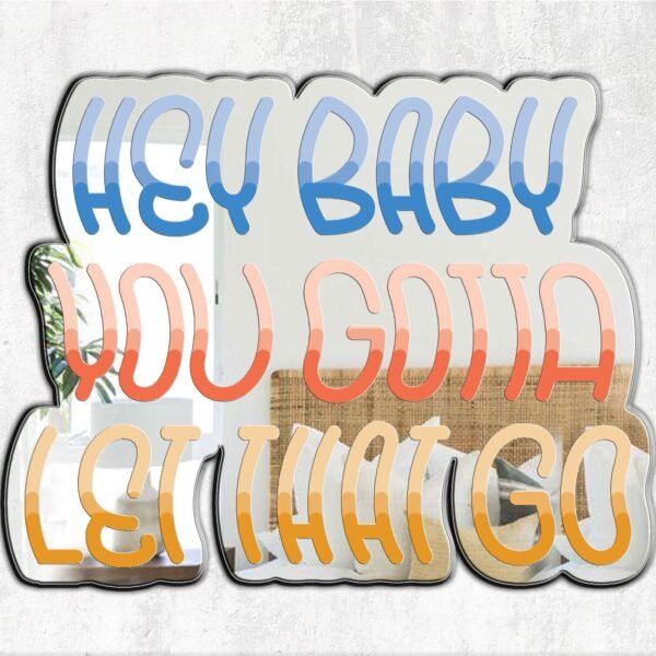 A custom-painted mirror with the quote "Hey Baby Let That Go" in an elegant font.