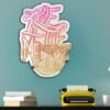 A custom-painted mirror featuring the phrase "Live in the Moment" with a sunset design.