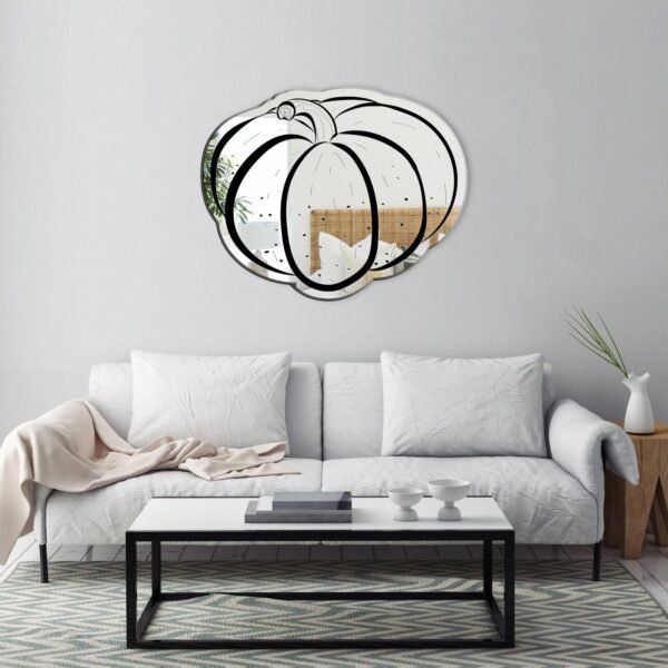 Decorative kitchen mirror with a pumpkin design.