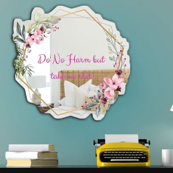 A mirror with the phrase "Do No Harm" in decorative font, surrounded by floral elements, offering a calming, nature-inspired message.