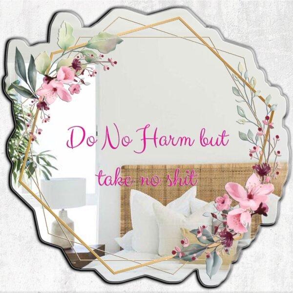 A mirror featuring the words "Do No Harm" in decorative lettering, surrounded by delicate floral designs.
