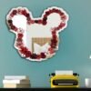 A decorative mirror featuring a floral Mickey Mouse design, blending playful and nature-inspired elements.