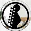 Mirror designed with a guitar headstock badge emblem, ideal for music lovers.