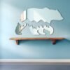 Bear silhouette overlay on mountain mirror.