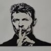 Mirror wall art featuring a printed face of David Bowie.