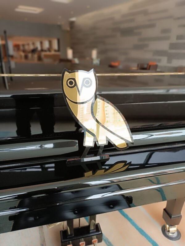 OVO owl motif at the top of a sleek mirror.