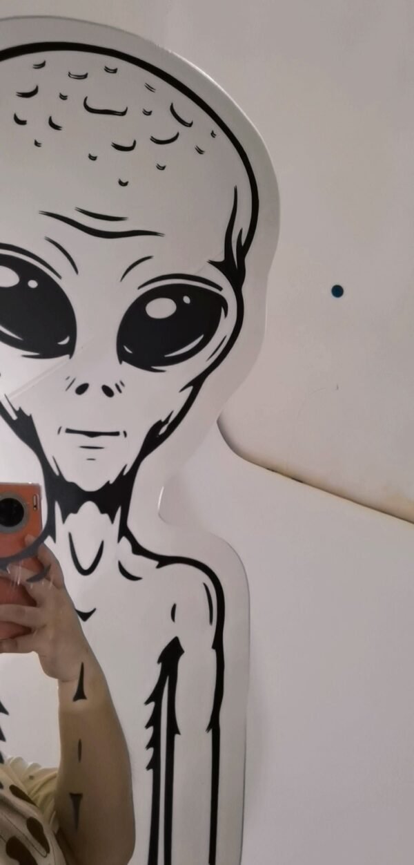 Stylish alien-themed decorative wall mirror.