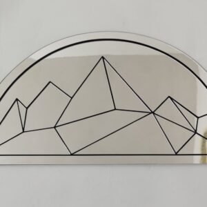 Wall mirror shaped like mountain peaks with a geometric design.