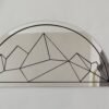 Geometric wall-mounted mountain range mirror.