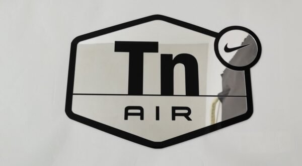 Glossy mirror sign with Air Max TN detail.