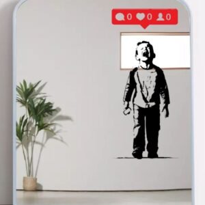 Printed wall art of a Banksy-style mural depicting a crying child with a mirror.