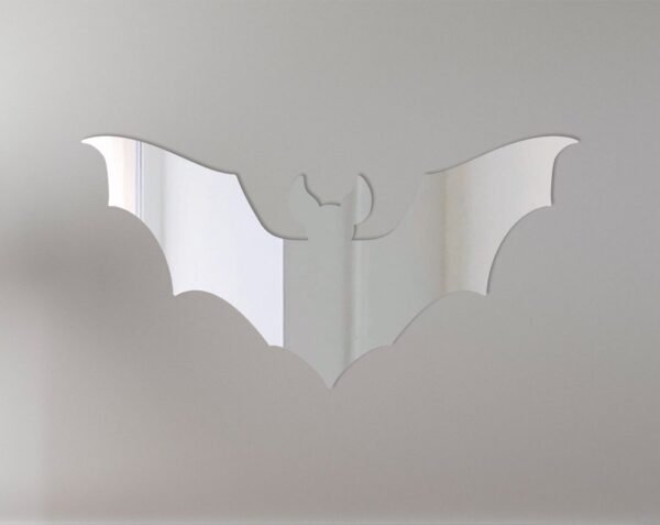 Bat-shaped mirror with 'Welcome' text in gothic font.