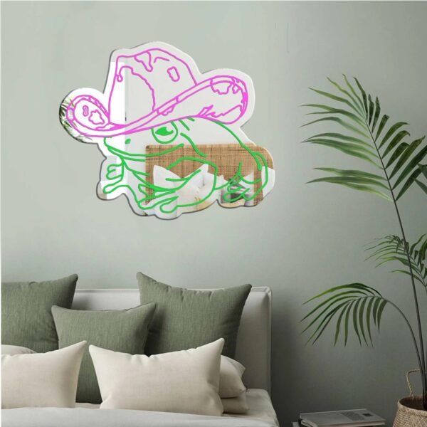 Mirror wall art featuring a whimsical frog in cowgirl attire