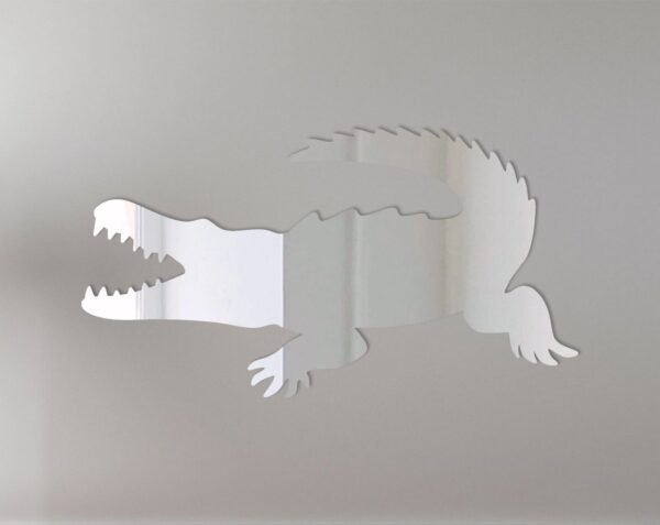 Reflective crocodile-shaped sign with mirror finish.