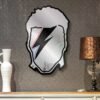 Reflective mirror with David Bowie's iconic image.