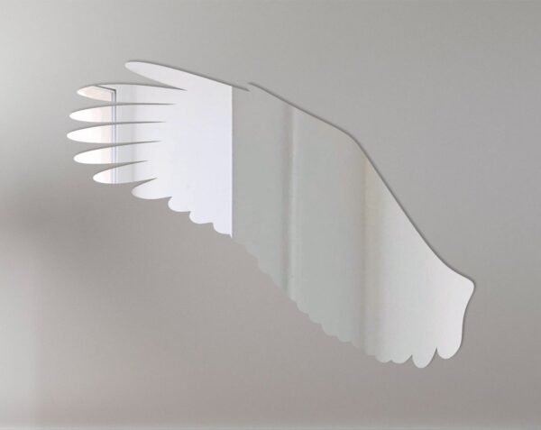 Eagle-shaped mirror with wings as frame on wall.