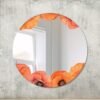 Decorative mirror encircled by a floral print pattern.