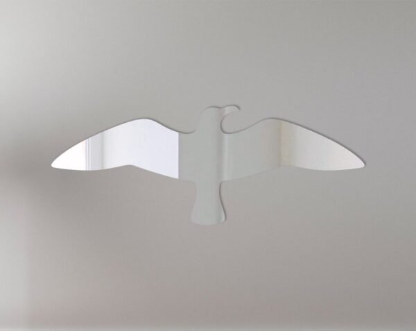 Mirror sign shaped like a flying seagull with reflective surface.