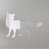 Decorative fox-shaped mirror with ornate border hanging on a wall.