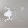 Frog-shaped mirror with a 'Welcome' sign hanging below.