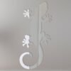 Reflective gecko-shaped mirror sign with vibrant colors.