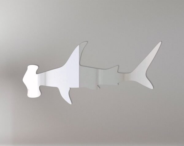 Wall sign shaped like a hammerhead shark with mirrored surface.