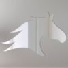 Horse head-shaped mirror with reflective surface and frame.